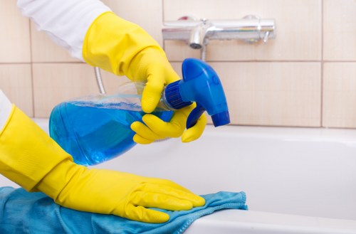 Technician performing upholstery cleaning on a sectional sofa